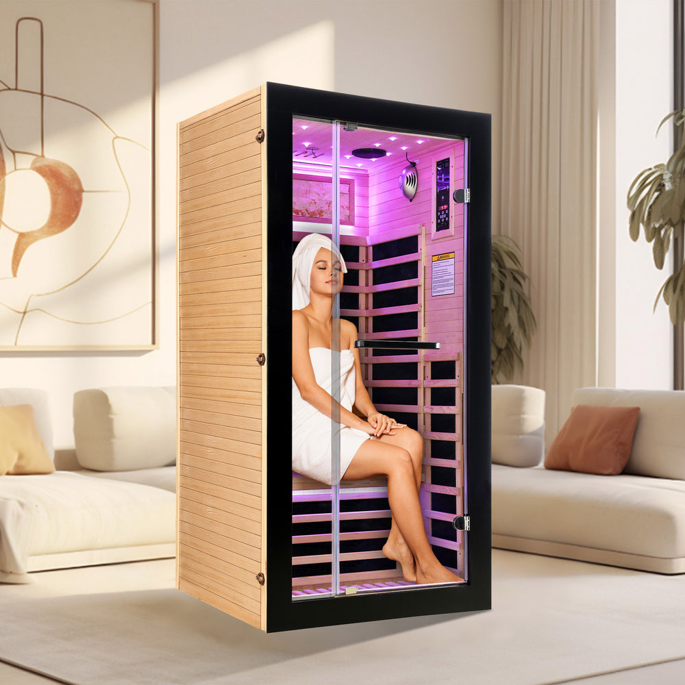 A female model sitting inside a single sauna indoor A female model sitting inside a single sauna indoor