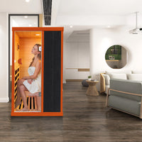 Woman in the Outexer T-50C5 infrared sauna with a modern living room in the background Woman in the Outexer T-50C5 infrared sauna with a modern living room in the background