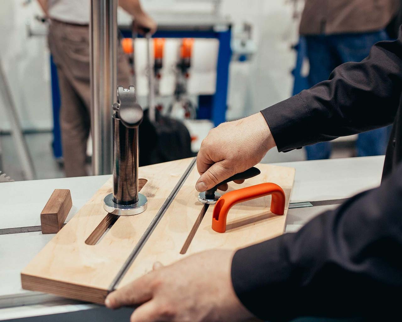 Outexer's worker is cutting a wooden board