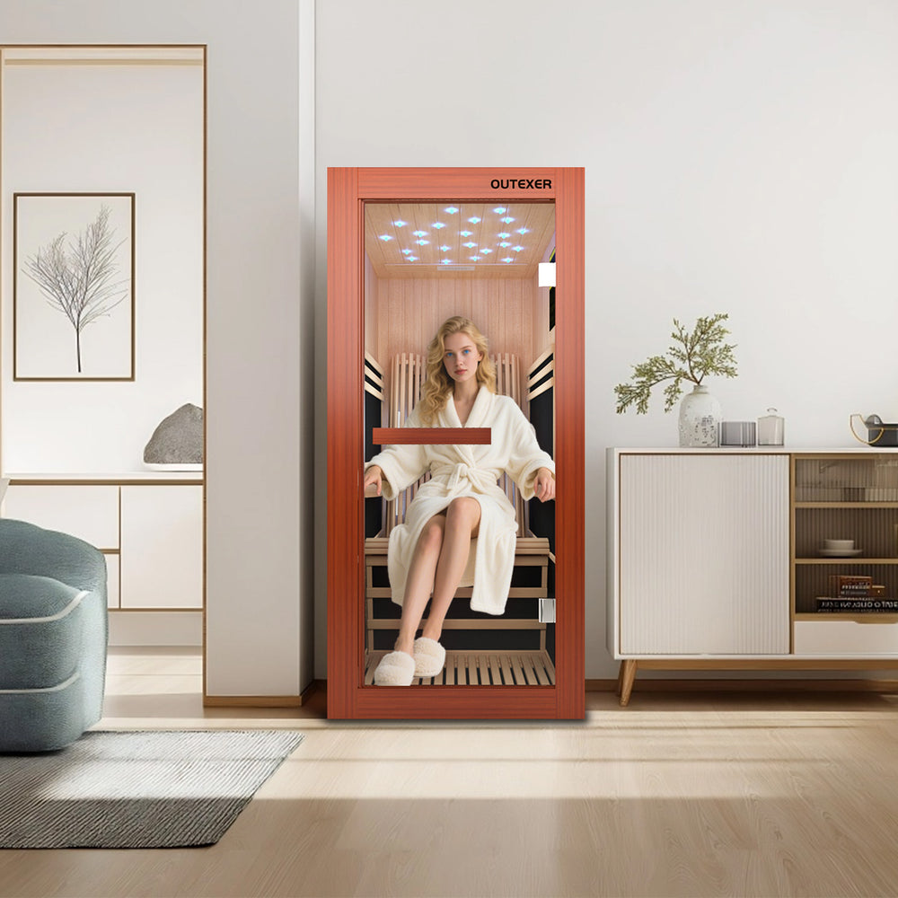 A Woman sitting inside a infrared sauna with 'OUTEXER' branding, reflected in a mirror.