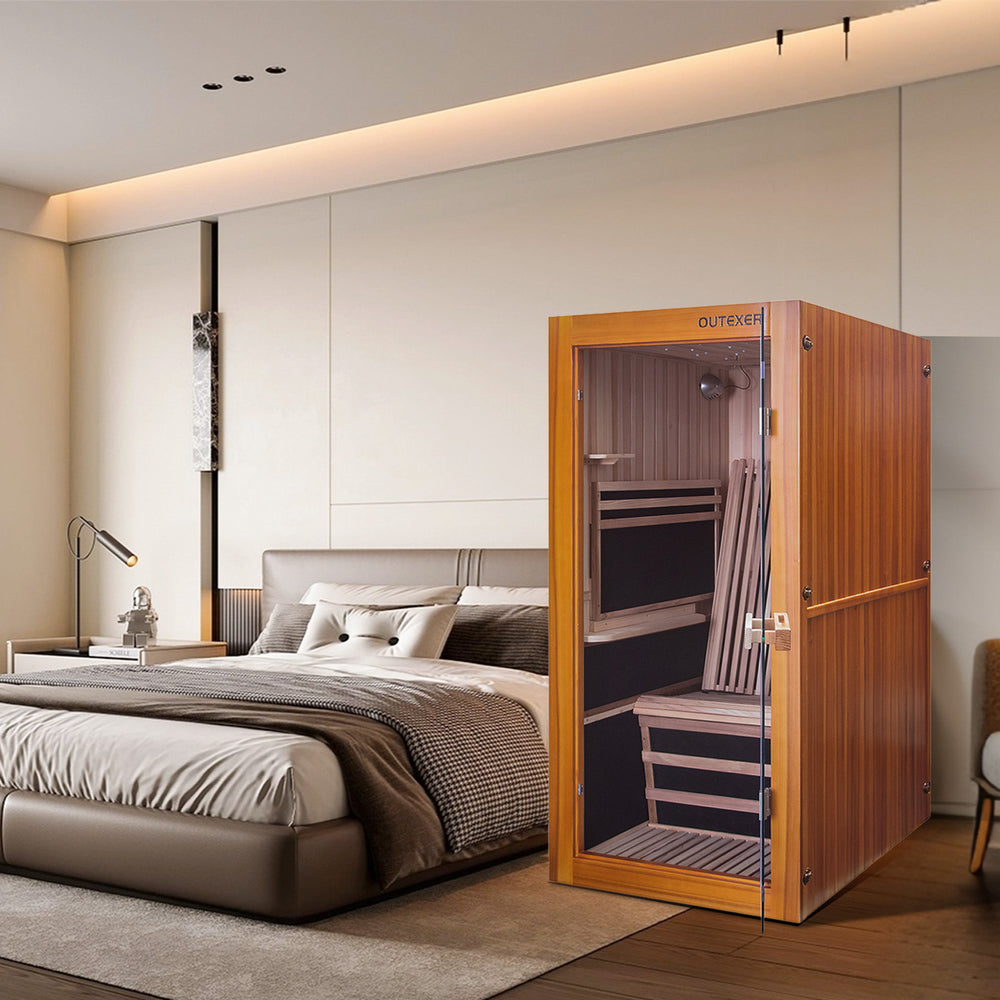 HK6 indoor sauna in a modern bedroom setting with a bed and mirror.