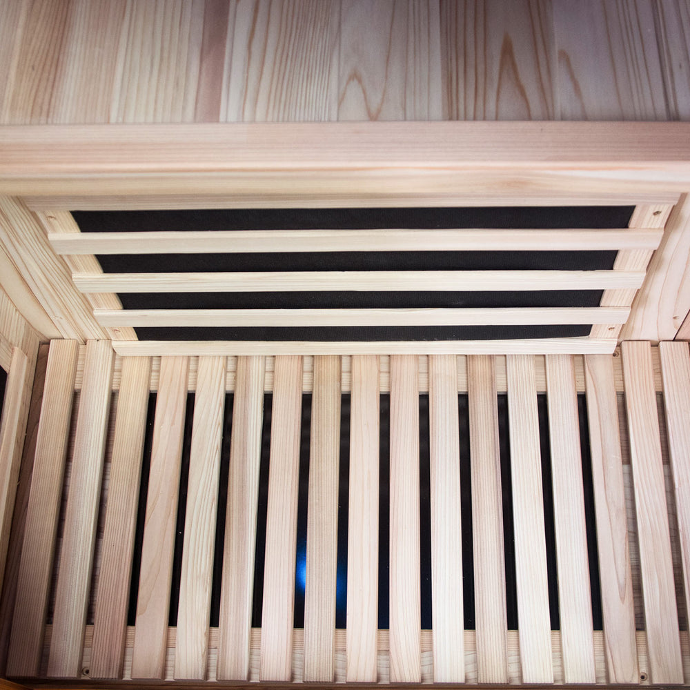 Wooden sauna with steam generator visible inside