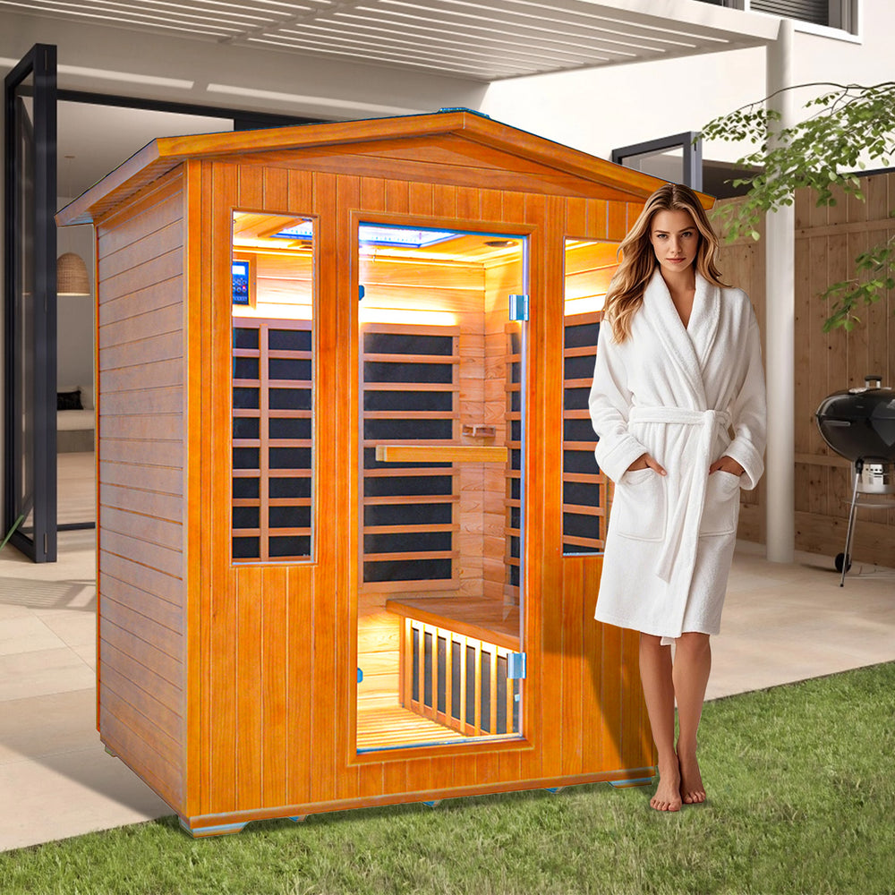 Woman in a white robe standing next to a Outexer sauna in an outdoor setting.