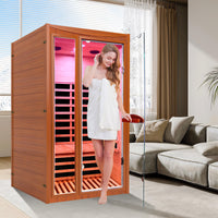 Woman entering the Outxer infrared sauna in a modern living room.