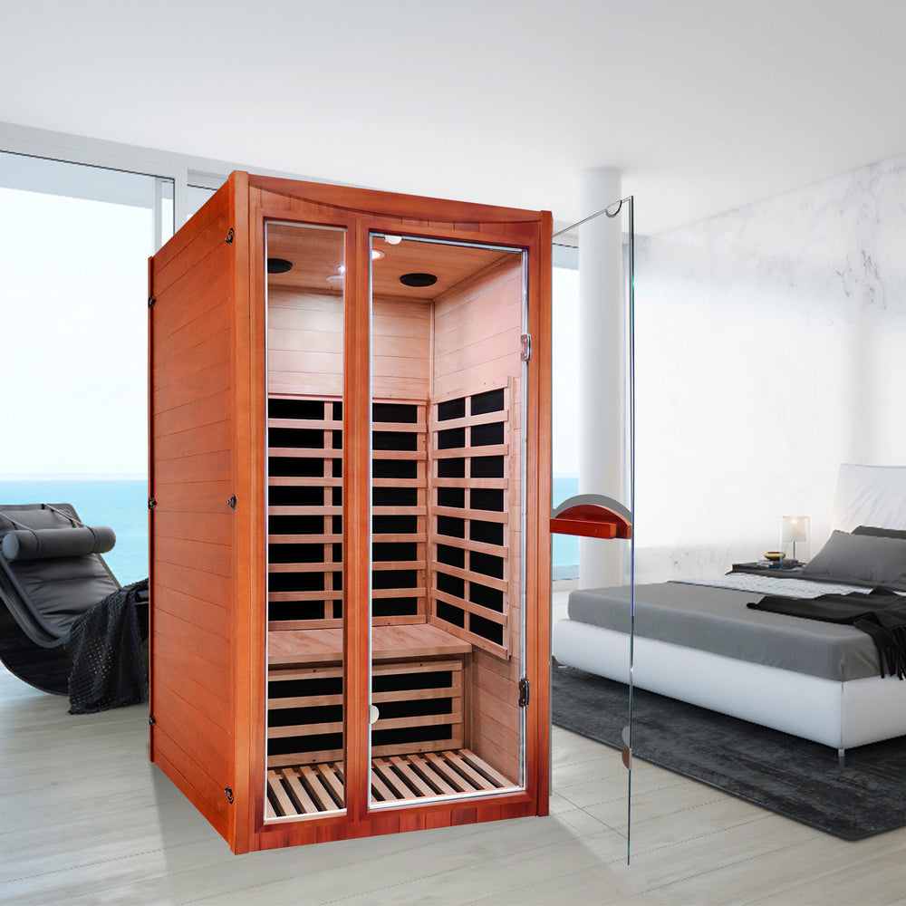 Outxer sauna T-51C5 with glass door in a modern room with a bed and chair.