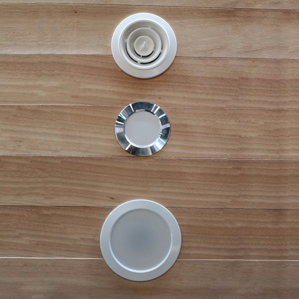 Three circular metallic objects on a wooden