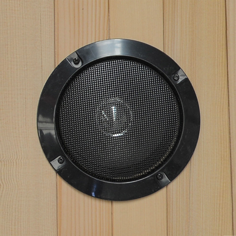 Black speaker grille on a wooden panel
