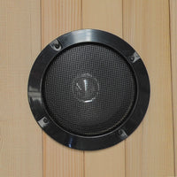 Black speaker grille on a wooden panel