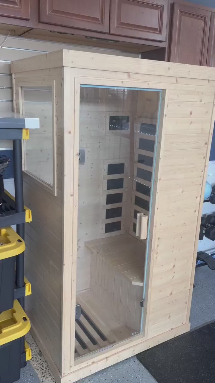 Outexer infrared sauna customer demonstrating the control panel, interior lighting, and sauna cabin.