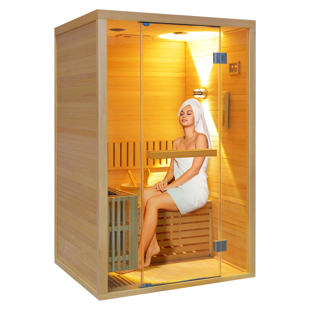 Woman sitting inside a traditional sauna HY8 with warm lighting